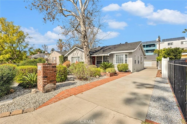 view of front of property with a fenced front yard and stucco siding