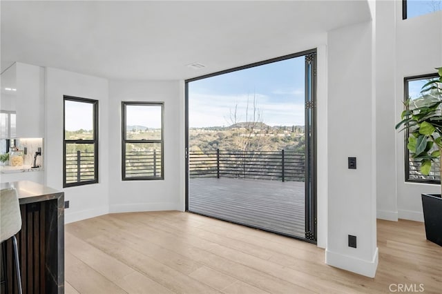 interior space with light wood finished floors and baseboards