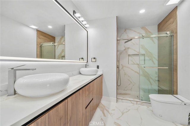 full bathroom with double vanity, a sink, and a marble finish shower