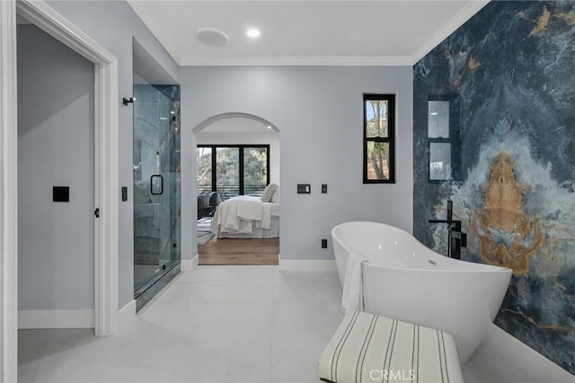 bathroom featuring a soaking tub, ensuite bath, ornamental molding, and baseboards