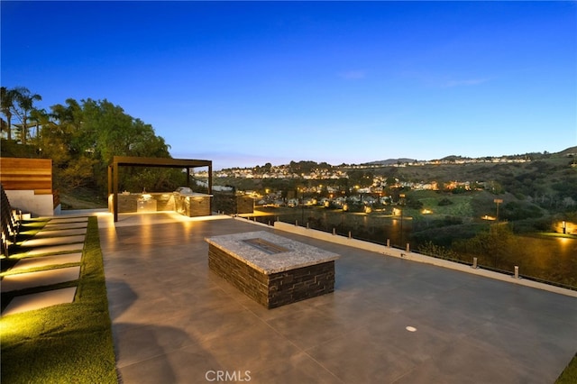 view of patio with a fire pit and area for grilling