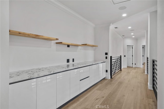 kitchen featuring modern cabinets, white cabinetry, open shelves, and light stone counters