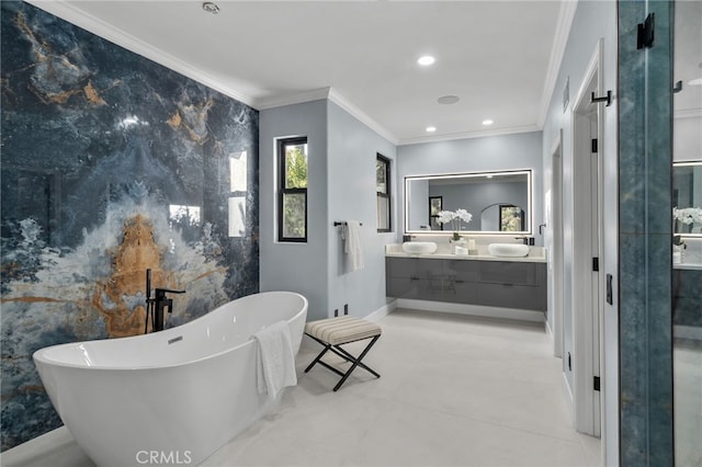 full bath with double vanity, recessed lighting, a soaking tub, ornamental molding, and baseboards