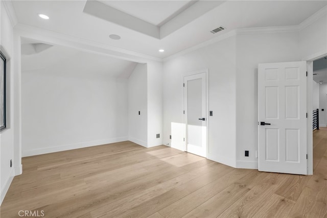 unfurnished bedroom featuring light wood-style floors, baseboards, visible vents, and crown molding