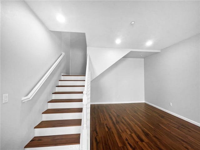 stairway with recessed lighting, baseboards, and wood finished floors