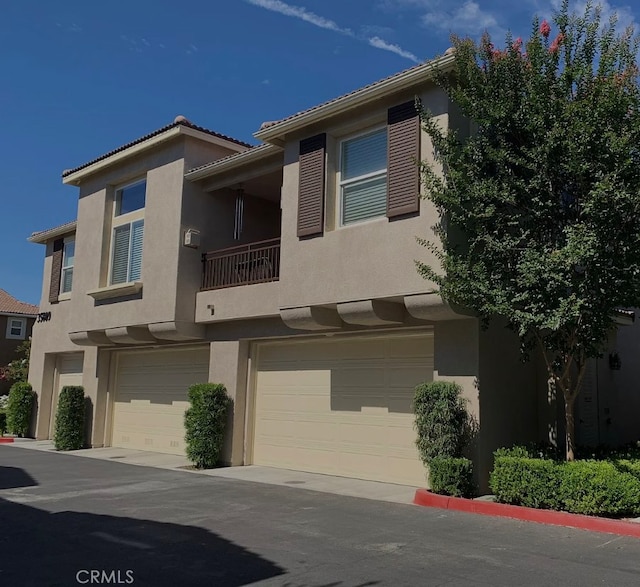 view of property with stucco siding and a garage