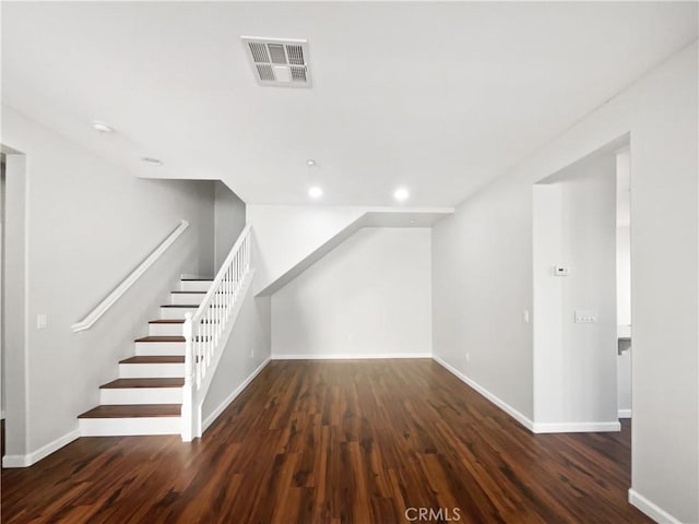 additional living space with stairway, recessed lighting, baseboards, visible vents, and wood finished floors