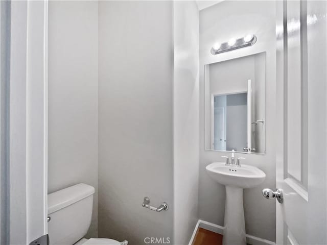 bathroom featuring a sink and toilet