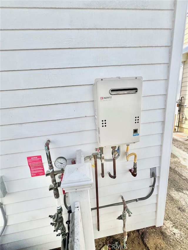 exterior details featuring tankless water heater