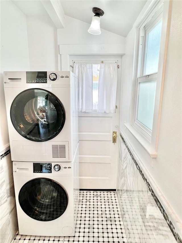 laundry area with stacked washer and clothes dryer and laundry area