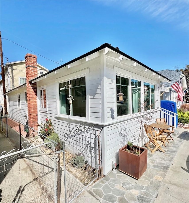 view of home's exterior featuring a gate and fence