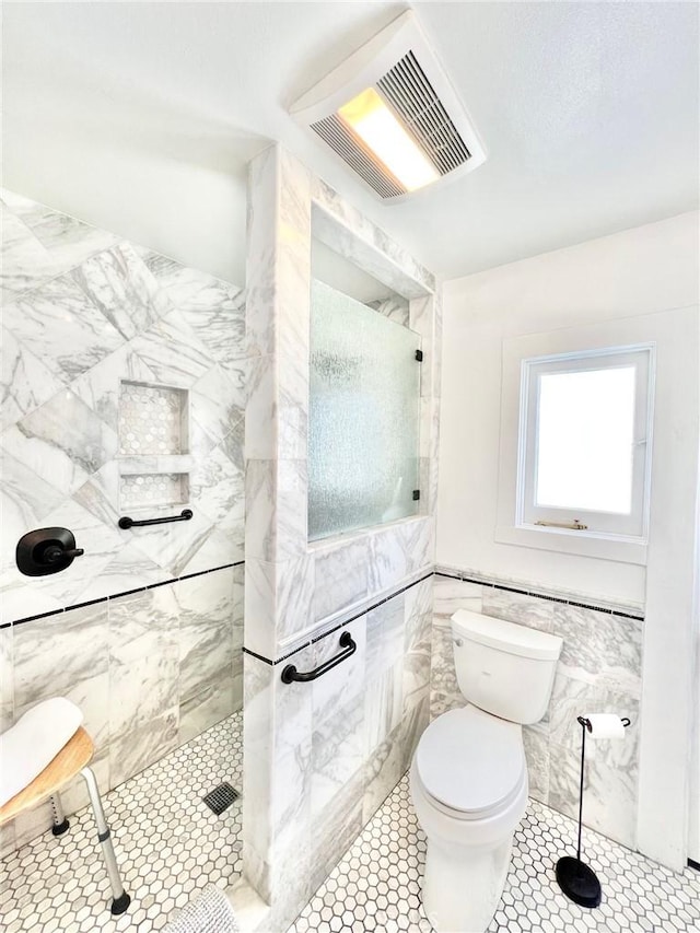 full bathroom featuring visible vents, toilet, tile patterned flooring, walk in shower, and tile walls