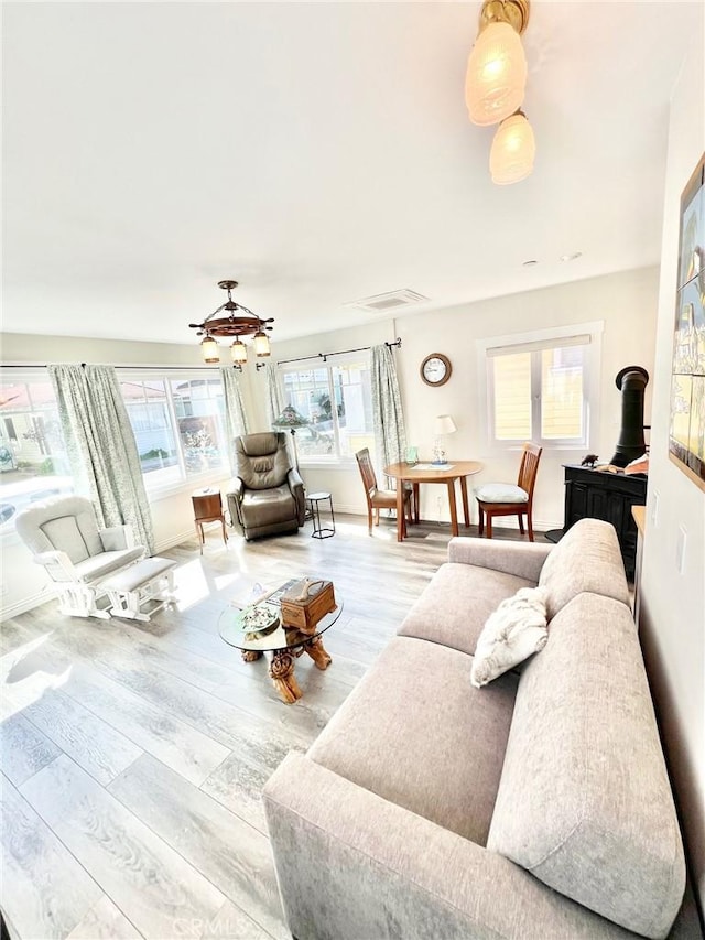 living room featuring visible vents and wood finished floors