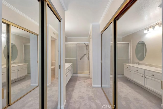 full bathroom with ornamental molding, vanity, and a shower stall