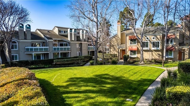 surrounding community featuring a residential view and a lawn