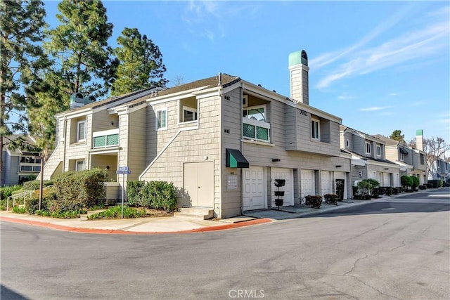 view of property featuring a garage and a residential view