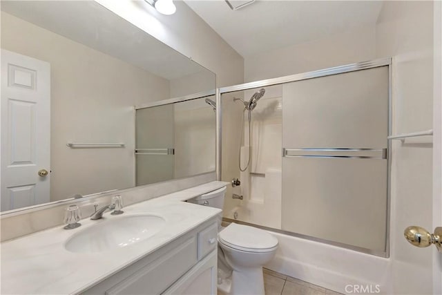 full bathroom featuring toilet, enclosed tub / shower combo, vanity, and tile patterned floors