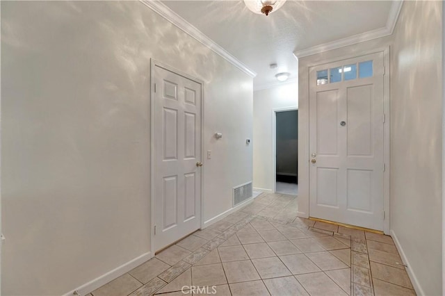 entrance foyer featuring ornamental molding, visible vents, baseboards, and light tile patterned floors