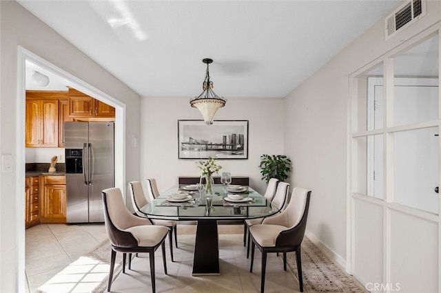 dining area featuring visible vents and light tile patterned flooring