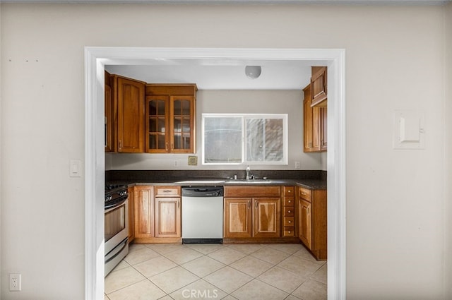 bar featuring appliances with stainless steel finishes, a sink, and light tile patterned floors