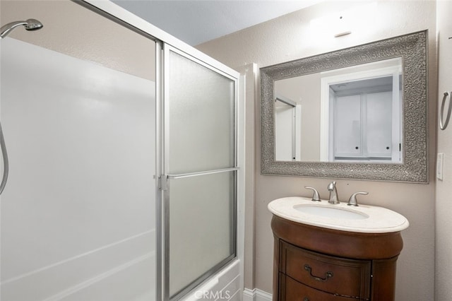 bathroom featuring enclosed tub / shower combo and vanity