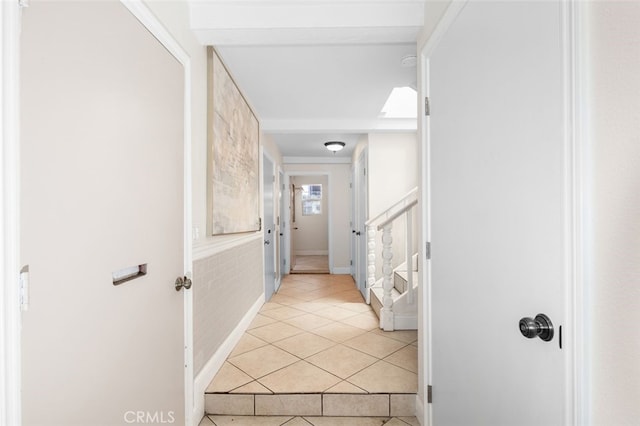 hallway featuring tile patterned flooring and stairway