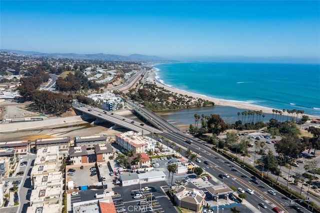 drone / aerial view featuring a water view and a beach view