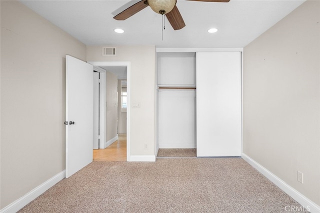 unfurnished bedroom featuring baseboards, light colored carpet, ceiling fan, a closet, and recessed lighting