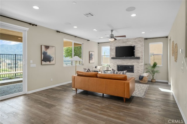 11781 Stonefield Dr, Corona, CA 92883 - living room featuring baseboards, a stone fireplace, dark wood-style floors, visible vents, and ceiling fan