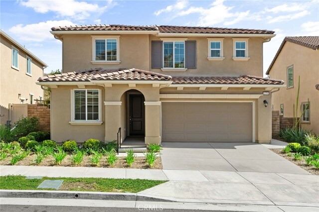 11781 Stonefield Dr, Corona, CA 92883 - mediterranean / spanish home featuring concrete driveway, stucco siding, a garage, a tiled roof, and fence