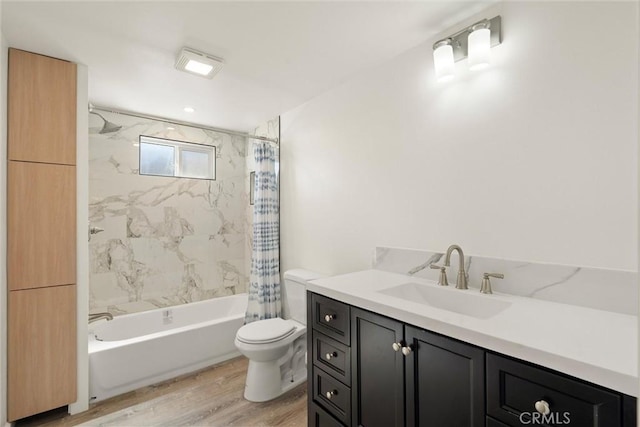 bathroom with vanity, toilet, wood finished floors, and shower / bath combo