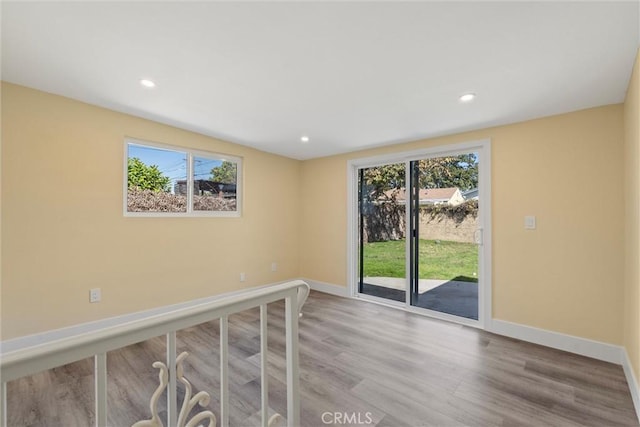 unfurnished room with recessed lighting, baseboards, and wood finished floors