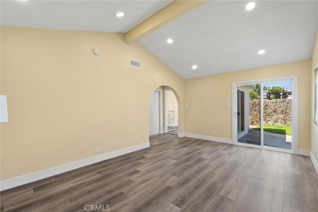 empty room with wood finished floors, visible vents, baseboards, vaulted ceiling with beams, and arched walkways