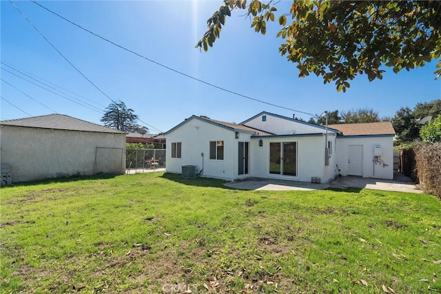 back of property featuring a patio, a yard, fence, and stucco siding