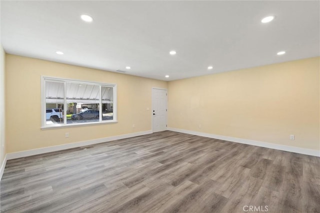 empty room with recessed lighting and baseboards