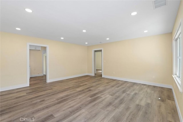 spare room featuring visible vents, recessed lighting, light wood-type flooring, and baseboards