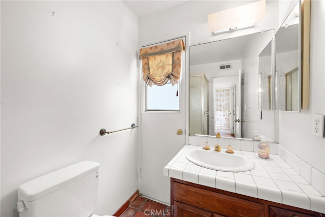 bathroom featuring visible vents, toilet, and vanity