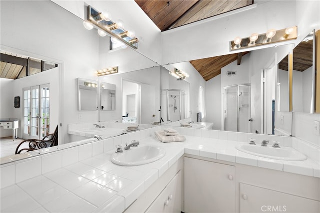 bathroom featuring a sink, wooden ceiling, a stall shower, and vaulted ceiling