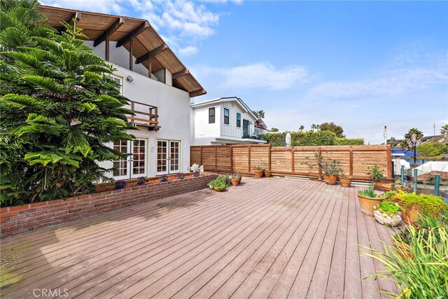 deck featuring fence and french doors