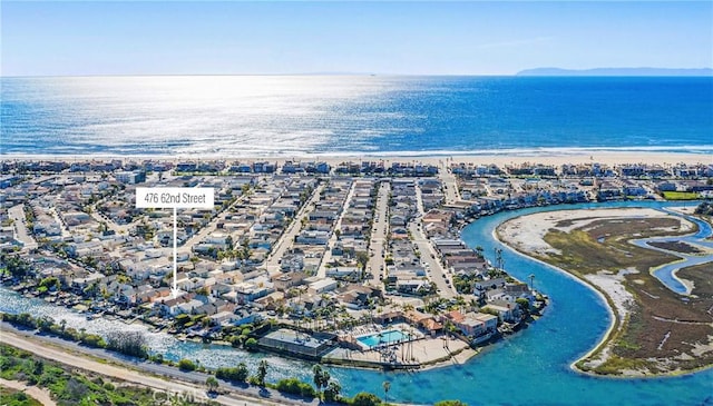birds eye view of property with a water view and a view of the beach