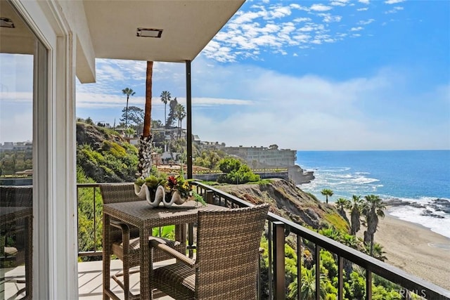 balcony with a water view and a beach view