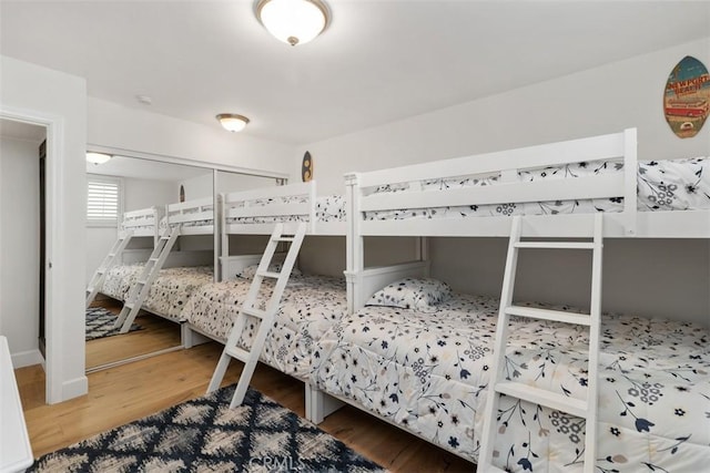 bedroom featuring baseboards and wood finished floors