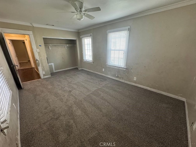 unfurnished bedroom with crown molding, a closet, visible vents, carpet flooring, and baseboards