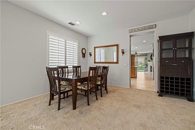 dining room featuring recessed lighting, visible vents, and light colored carpet