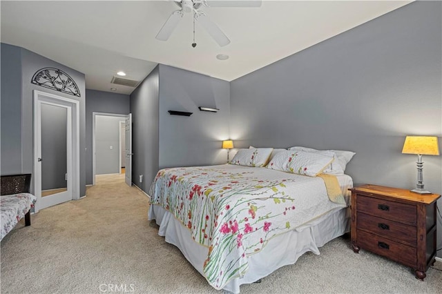 bedroom featuring ceiling fan, baseboards, visible vents, and light colored carpet