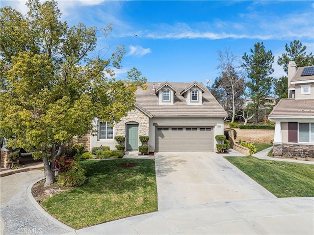 view of front facade featuring a garage, concrete driveway, stone siding, a front lawn, and stucco siding