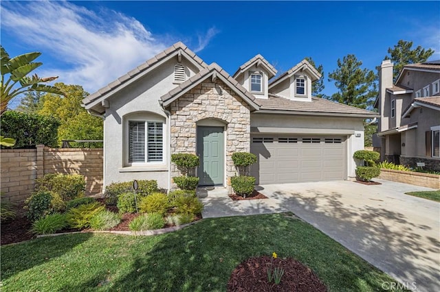 view of front of home with concrete driveway, stone siding, an attached garage, a front lawn, and stucco siding