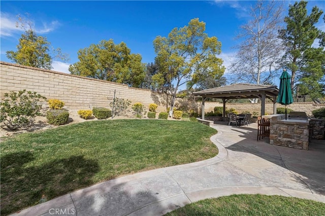 view of home's community with a patio, an outdoor kitchen, a fenced backyard, a gazebo, and a yard