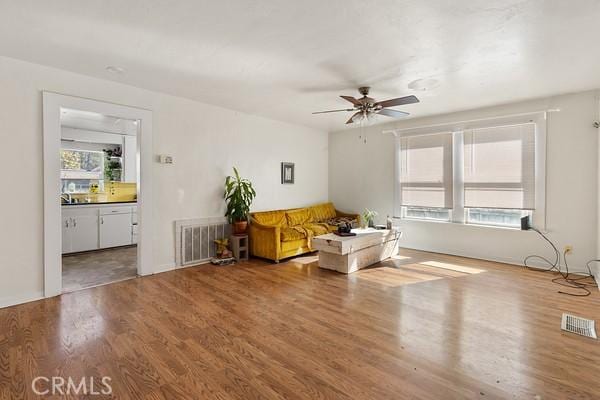 unfurnished room featuring visible vents, ceiling fan, and wood finished floors