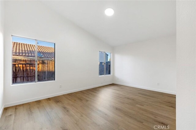 2203 Scott Ave, Palmdale, CA 93550 - unfurnished room with high vaulted ceiling, baseboards, and wood finished floors